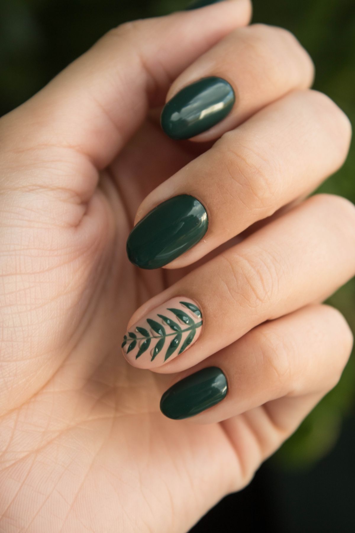 Custom hand-painted nail art with botanical detail